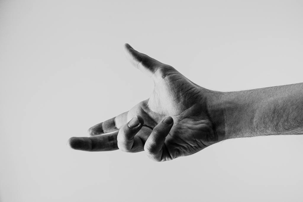 Greyscale photo of outstretched hand